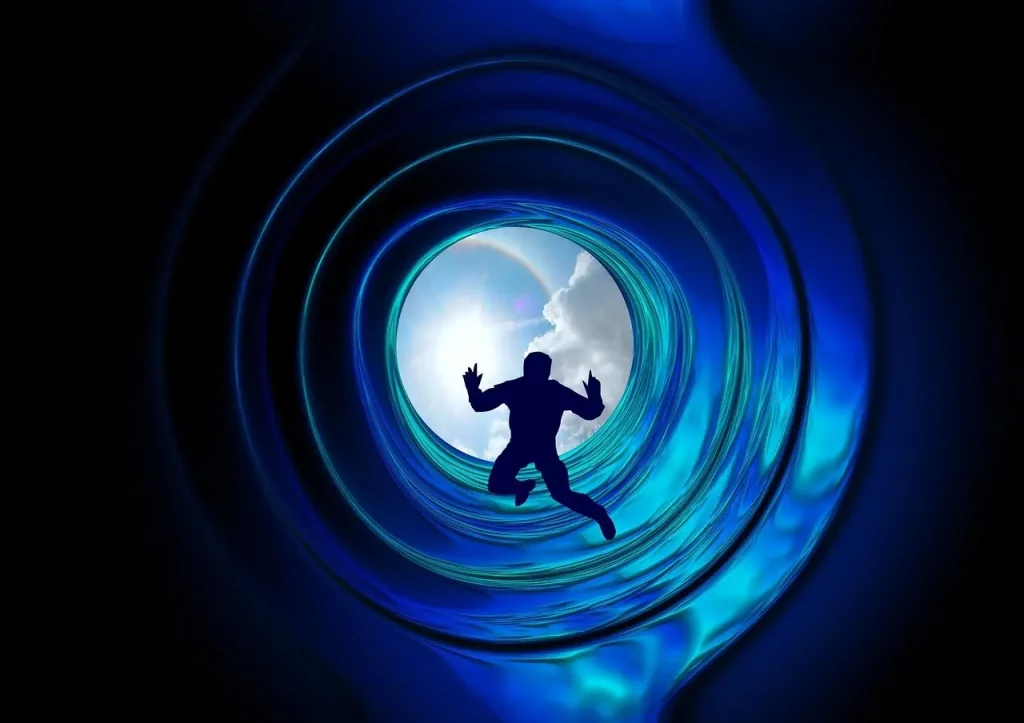 Découvrez cette image évocatrice : une personne dans un tunnel bleuté, menant vers le ciel et une lumière intense. Une représentation symbolique du passage de l'âme après la mort du corps physique. Plongez dans la vision spirituelle de cette transition vers une dimension lumineuse au-delà de notre réalité terrestre.